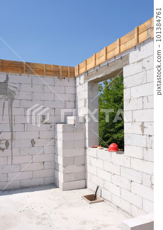 Building a house from a white gas block or foam block at a construction site. Building a house from a white gas block or foam block at a construction site. 101384761