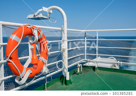 Orange lifebuoy on the deck of a cruise ship. Transport and travel concept Orange lifebuoy on the deck of a cruise ship. Transport and travel concept 101385281