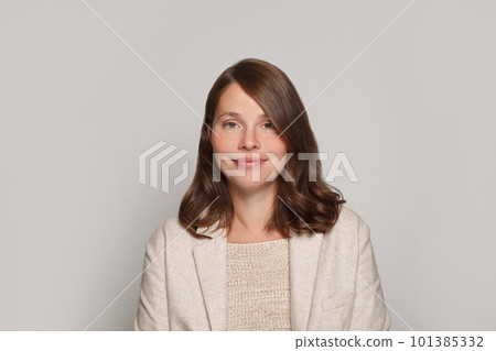 Studio portrait of smiling positive cheerful business woman in white casual suit 101385332