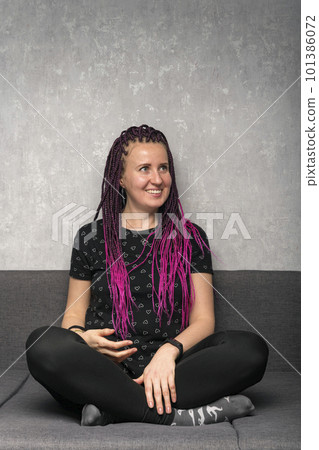 Young smiling woman with color dreadlocks portrait profile on grey background. Vertical frame. Hipster style. 101386072
