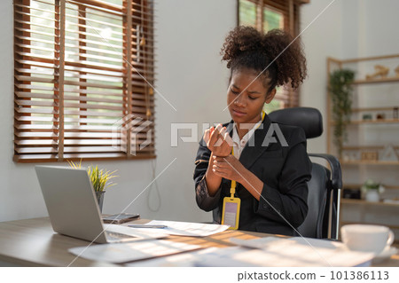 Wrist pain, business woman and muscle injury while sitting at desk and working as a data analyst. Hand of a black female entrepreneur suffering from carpal tunnel syndrome or arthritis in office 101386113