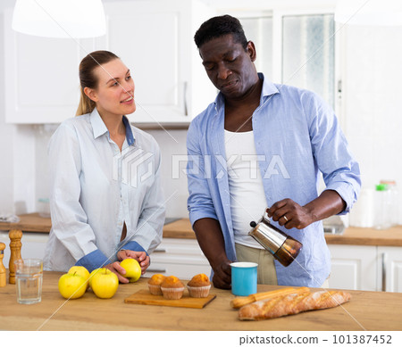 Husband and wife having breakfast together at home 101387452