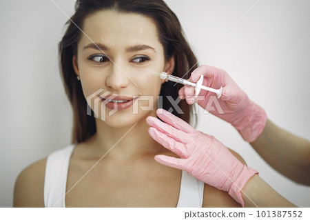 Cosmetologist with a prick. Woman with cosmetologist. Lady in a beauty studio. 101387552