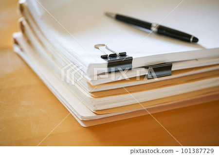 Documents stacked on the desk Paper documents 101387729