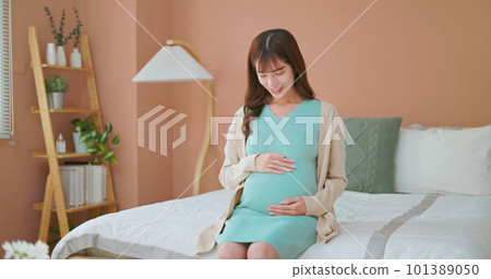 asia woman pregnant stroking belly 101389050