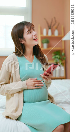 asian woman pregnant scroll mobile 101389051