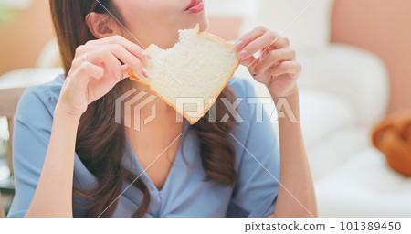 asian woman biting toast happily asian woman biting toast happily 101389450
