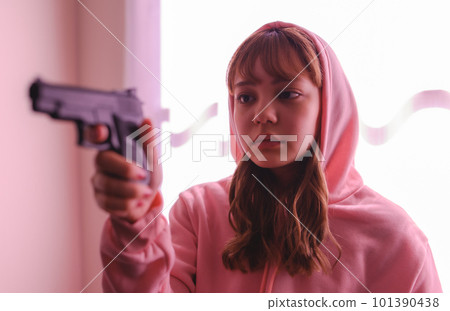 A scene like a movie of a woman holding a gun A scene like a movie of a woman holding a gun 101390438