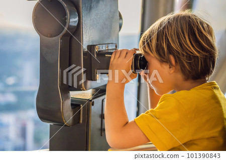 Little boy looks at Kuala lumpur cityscape. Panoramic view of Kuala Lumpur city skyline evening at sunset skyscrapers building in Malaysia. Traveling with kids concept 101390843