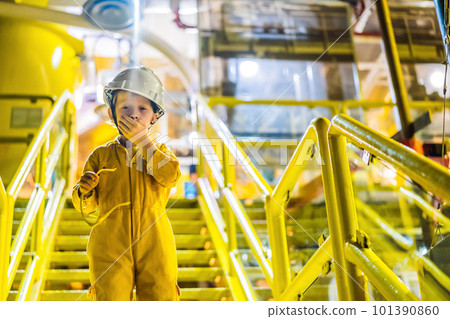 Boy operator recording operation of oil and gas process at oil and rig plant, offshore oil and gas industry, offshore oil and rig in the sea, operator monitor production process, routine daily record 101390860