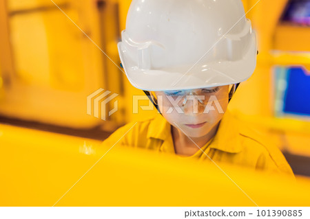 Boy operator recording operation of oil and gas process at oil and rig plant, offshore oil and gas industry, offshore oil and rig in the sea, operator monitor production process, routine daily record 101390885