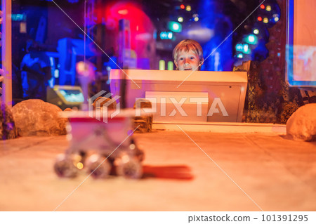 The boy controls the toy rover on Mars. Flight to Mars concept The boy controls the toy rover on Mars. Flight to Mars concept 101391295