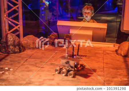 The boy controls the toy rover on Mars. Flight to Mars concept 101391298