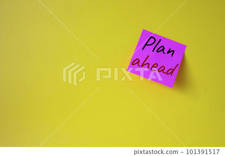 Plan ahead symbol. Pink steaky note with words Plan ahead. Beautiful yellow background. Business and Plan ahead concept. Copy space. Plan ahead symbol. Pink steaky note with words Plan ahead. Beautiful yellow background. Business and Plan ahead concept. Copy space. 101391517