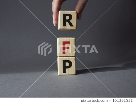 RFP - Request for Proposal. Wooden cubes with word RFP. Businessman hand. Beautiful grey background. Business and Request for Proposal concept. Copy space. RFP - Request for Proposal. Wooden cubes with word RFP. Businessman hand. Beautiful grey background. Business and Request for Proposal concept. Copy space. 101391531