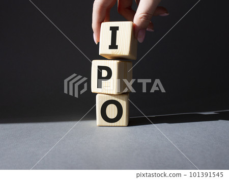 IPO- Initial Public Offering symbol. Concept word IPO on wooden cubes. Businessman hand. Beautiful grey background. Business and IPO concept. Copy space. IPO- Initial Public Offering symbol. Concept word IPO on wooden cubes. Businessman hand. Beautiful grey background. Business and IPO concept. Copy space. 101391545