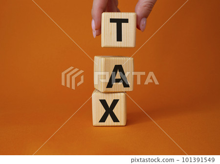 TAX - Shortness of breath symbol. Wooden cubes with words TAX. Businessman hand. Beautiful orange background. Business and TAX concept. Copy space. TAX - Shortness of breath symbol. Wooden cubes with words TAX. Businessman hand. Beautiful orange background. Business and TAX concept. Copy space. 101391549