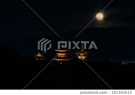 Night view of Yakushiji Temple with dim winter moon 101391613