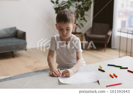 Six years old boy drawing with pencils. Six years old boy drawing with pencils. 101391643