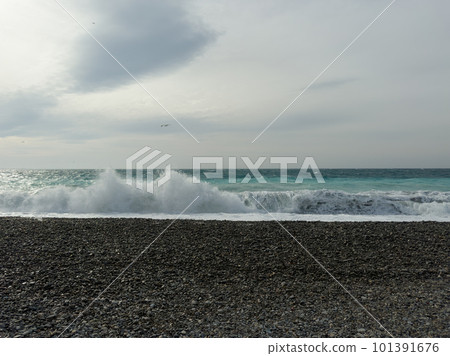 Pebble beach of Nice, France with azure waves of mediterranean sea 101391676