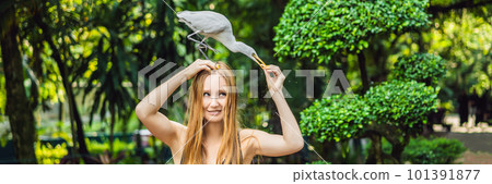 Young woman feeding ibes in the park. Little Egret Cattle egret Bubulcus ibis Waters Edge BANNER, LONG FORMAT 101391877