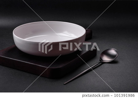 White empty soup bowl on a dark concrete background White empty soup bowl on a dark concrete background 101391986