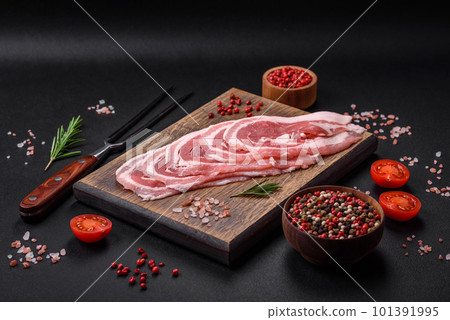 Fresh raw bacon sliced with spices and herbs 101391995