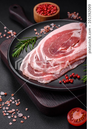 Fresh raw bacon sliced with spices and herbs 101392009