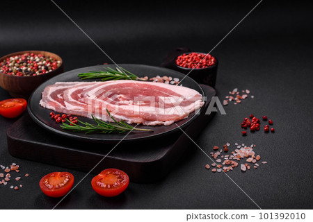 Fresh raw bacon sliced with spices and herbs 101392010