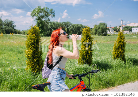 Young woman in the city rides bike and leads an active lifestyle doing sports 101392146