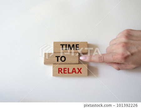 Time to relax symbol. Concept word Time to relax on wooden blocks. Businessman hand. Beautiful white background. Business and Time to relax concept. Copy space 101392226