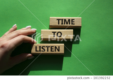 Time to listen symbol. Wooden blocks with words Time to listen. Beautiful green background. Businessman hand. Business and Active listening concept. Copy space. Time to listen symbol. Wooden blocks with words Time to listen. Beautiful green background. Businessman hand. Business and Active listening concept. Copy space. 101392232