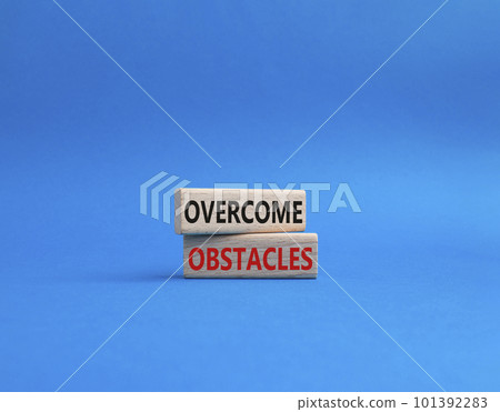 Overcome obstacles symbol. Concept words Overcome obstacles on wooden blocks. Beautiful blue background. Business and Overcome obstacles concept. Copy space. Overcome obstacles symbol. Concept words Overcome obstacles on wooden blocks. Beautiful blue background. Business and Overcome obstacles concept. Copy space. 101392283