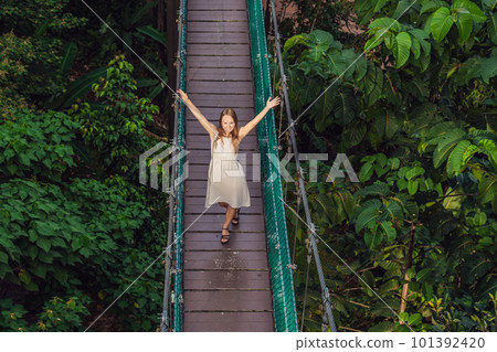 Young woman at the Suspension bridge in Kuala Lumpur, Malaysia 101392420
