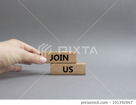 Join us symbol. Concept word Join us on wooden blocks. Beautiful grey background. Businessman hand. Business and Join us concept. Copy space Join us symbol. Concept word Join us on wooden blocks. Beautiful grey background. Businessman hand. Business and Join us concept. Copy space 101392667