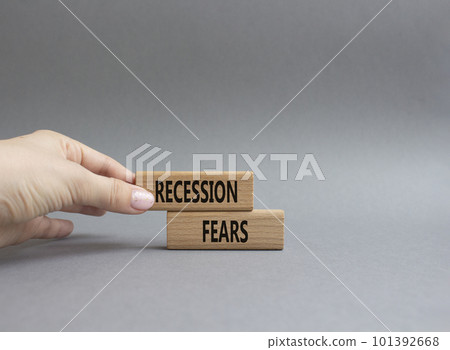 Recession fears symbol. Concept words Recession fears on wooden blocks. Beautiful grey background. Businessman hand. Business and Recession fears concept. Copy space. Recession fears symbol. Concept words Recession fears on wooden blocks. Beautiful grey background. Businessman hand. Business and Recession fears concept. Copy space. 101392668