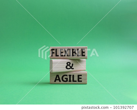 Flexible and agile symbol. Concept word Flexible and agile on wooden blocks. Beautiful green background. Business and Flexible and agile concept. Copy space 101392707