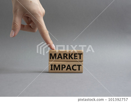 Market impact. Concept word Market impact on wooden cubes. Beautiful grey background. Businessman hand. Business and Market impact concept. Copy space. Market impact. Concept word Market impact on wooden cubes. Beautiful grey background. Businessman hand. Business and Market impact concept. Copy space. 101392757