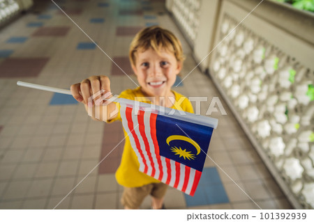 Boy travels in malaysia with malaysia flag celebrating the Malaysia independence day and Malaysia day. Travel to Malaysia concept Boy travels in malaysia with malaysia flag celebrating the Malaysia independence day and Malaysia day. Travel to Malaysia concept 101392939