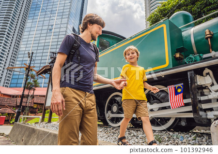 Father and son travelers in malaysia with malaysia flag celebrating the Malaysia independence day and Malaysia day. Travel to Malaysia concept Father and son travelers in malaysia with malaysia flag celebrating the Malaysia independence day and Malaysia day. Travel to Malaysia concept 101392946