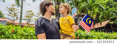 Father and son travelers in malaysia with malaysia flag celebrating the Malaysia independence day and Malaysia day. Travel to Malaysia concept BANNER, LONG FORMAT 101392953