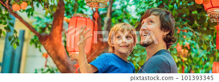Dad and son celebrate Chinese New Year look at Chinese red lanterns BANNER, LONG FORMAT Dad and son celebrate Chinese New Year look at Chinese red lanterns BANNER, LONG FORMAT 101393345