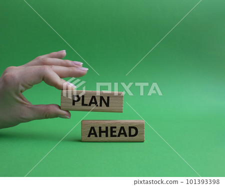 Plan ahead symbol. Wooden blocks with words Plan ahead. Beautiful green background. Businessman hand. Business and 'Plan ahead' concept. Copy space 101393398