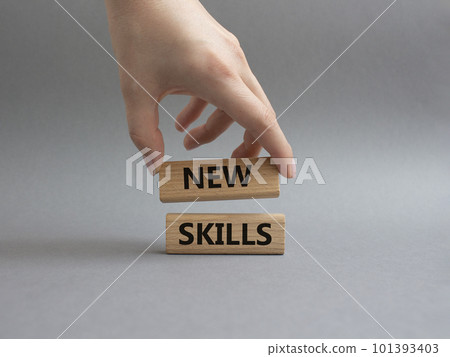 New skills symbol. Wooden blocks with words New skills. Beautiful grey background. Businessman hand. Business and New skills concept. Copy space. New skills symbol. Wooden blocks with words New skills. Beautiful grey background. Businessman hand. Business and New skills concept. Copy space. 101393403