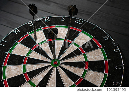 Three darts hit the dartboard. Lucky - one of the darts hits the bull's eye. The concept of winning Three darts hit the dartboard. Lucky - one of the darts hits the bull's eye. The concept of winning 101393493