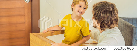 Father and son assembling furniture. Boy helping his dad at home. Happy Family concept BANNER, LONG FORMAT Father and son assembling furniture. Boy helping his dad at home. Happy Family concept BANNER, LONG FORMAT 101393660