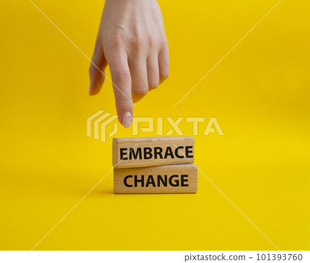 Embrace change symbol. Concept word Embrace change on wooden blocks. Beautiful yellow background. Businessman hand. Business and Embrace change concept. Copy space Embrace change symbol. Concept word Embrace change on wooden blocks. Beautiful yellow background. Businessman hand. Business and Embrace change concept. Copy space 101393760