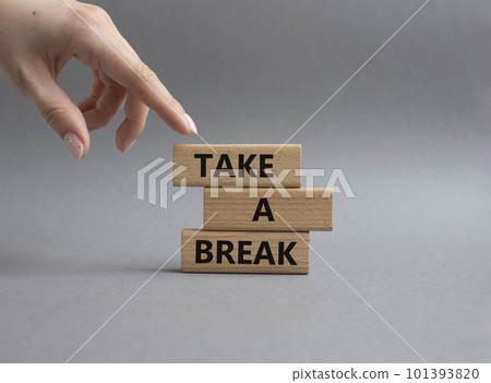 Take a break symbol. Concept words 'Take a break' on wooden blocks. Beautiful grey background. Businessman hand. Business and Take a break concept. Copy space. 101393820