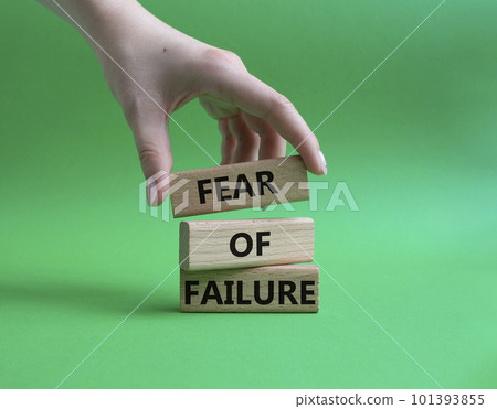 Fear of failure symbol. Concept words Fear of failure on wooden blocks. Beautiful green background. Businessman hand. Business and Fear of failure concept. Copy space. Fear of failure symbol. Concept words Fear of failure on wooden blocks. Beautiful green background. Businessman hand. Business and Fear of failure concept. Copy space. 101393855