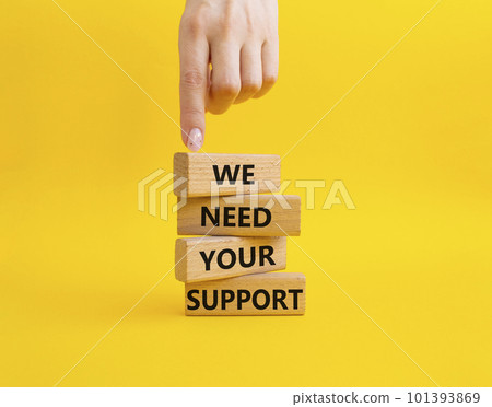 We need your support symbol. Wooden blocks with words We need your support. Beautiful yellow background. Businessman hand. Business and We need your support concept. Copy space. 101393869